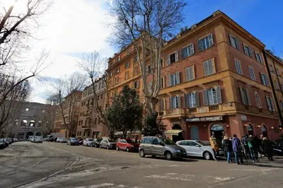a group of people standing in front of a building at dolce casa colosseo 1 - 2 in Rome