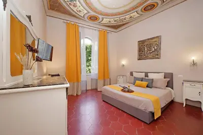 a bedroom with a large bed with a ceiling at dolce casa colosseo 1 - 2 in Rome