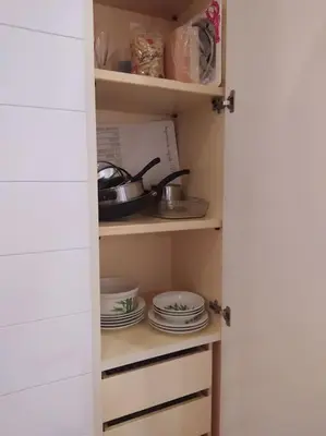 a kitchen pantry with plates and dishes in it at Irori Boutique House in Rome