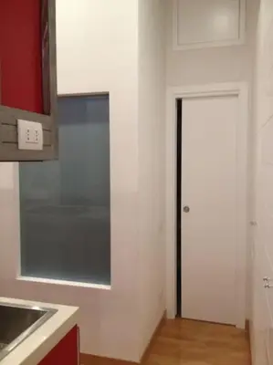 a kitchen with a sink and a door into a room at Irori Boutique House in Rome