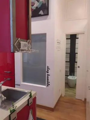 a kitchen with a sink and a toilet in a room at Irori Boutique House in Rome