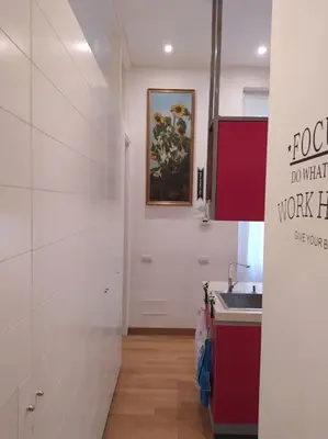 a kitchen with a sink and a painting on the wall at Irori Boutique House in Rome