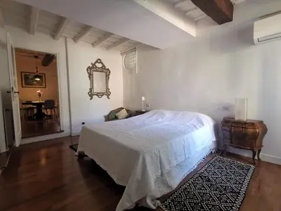 a bedroom with a bed and a table and a mirror at 