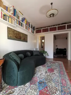 a living room with a green couch and a rug at 