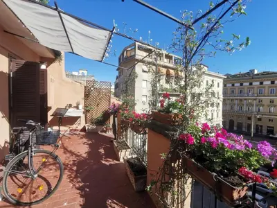 a bike parked on a balcony with flowers at 
