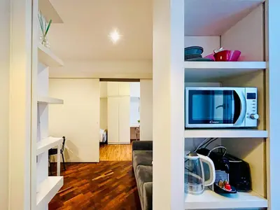 a living room with a couch and a microwave at Suite Vaticana 9 in Rome