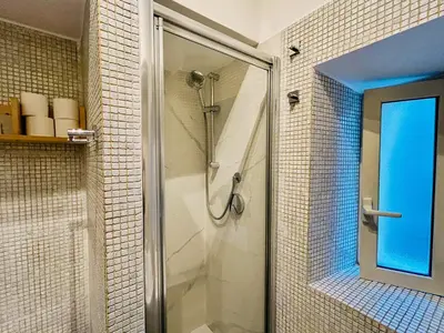 a shower with a glass door in a bathroom at Suite Vaticana 9 in Rome