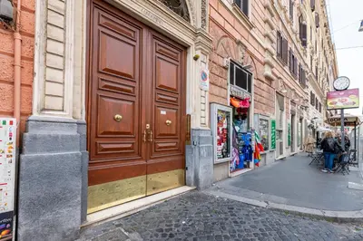 a building with a large wooden door on a street at Suite Vaticana 9 in Rome