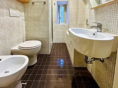 a bathroom with a sink and a toilet and a tub at Suite Vaticana 9 in Rome