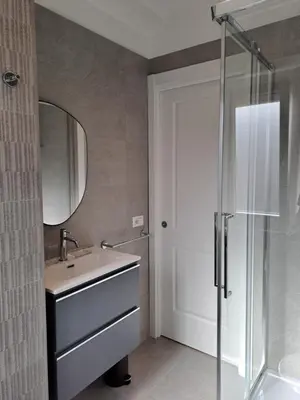 a bathroom with a sink and a mirror and a shower at Simon's House in Rome