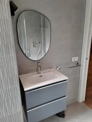 a bathroom with a white sink and a mirror at Simon's House in Rome