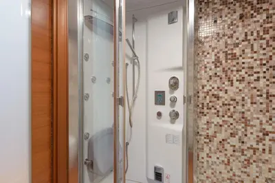 a shower with a glass door in a bathroom at Rome Guest House Saint Peter in Rome