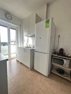 a bedroom with a bed and a tv and cabinets at Holiday Roma prenestina in Rome