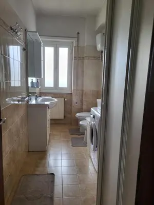 a kitchen with a table and a refrigerator at Holiday Roma prenestina in Rome
