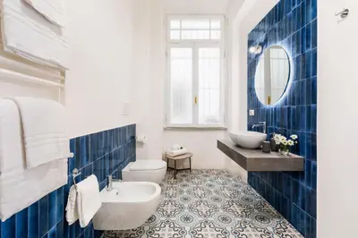a bathroom with a sink and a toilet and a mirror at Rome Nice Stays in Rome