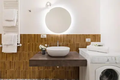 a bathroom with a sink and a washing machine at Rome Nice Stays in Rome