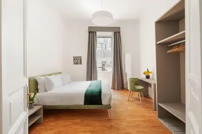a bedroom with a bed and a desk and a window at Rome Nice Stays in Rome
