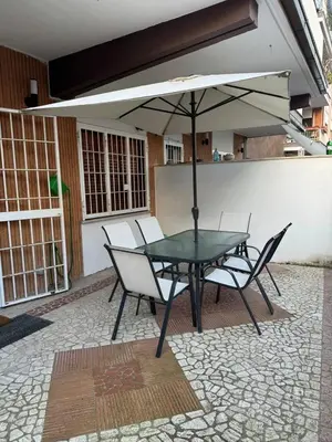 a table and chairs with an umbrella on a patio at camera con bagno privato in Rome