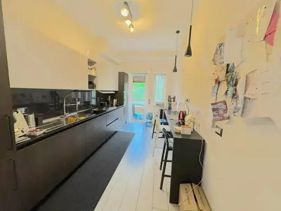 a kitchen with a counter and some chairs in it at camera con bagno privato in Rome