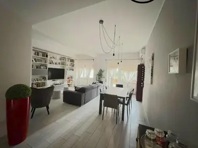 a living room with a table and a couch at camera con bagno privato in Rome