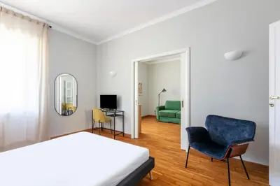 a bedroom with a bed and a chair and a television at Casa Fontanella by Hili in Rome