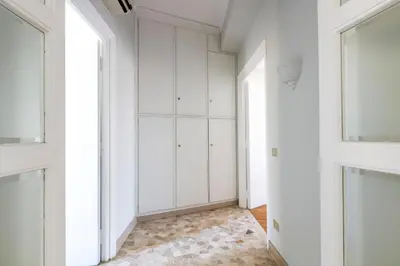 a room with white cabinets and a rug at Casa Fontanella by Hili in Rome