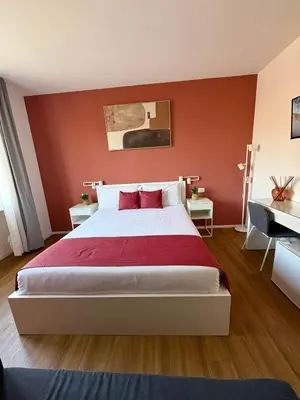 a bedroom with a white bed and a desk at Near Vatican, Irnerio 47 Guest House in Rome