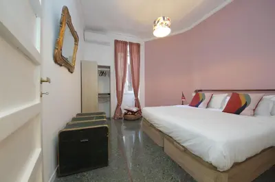 a bedroom with a large bed and a window at YCH-Vintage flat near San Giovanni in Rome