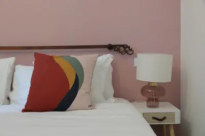 a bed with a pillow and a lamp on a table at YCH-Vintage flat near San Giovanni in Rome