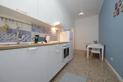 a small kitchen with a sink and a table at YCH-Vintage flat near San Giovanni in Rome