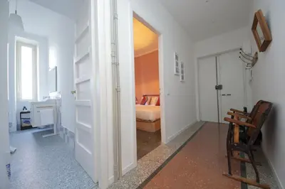 a room with a bedroom with a bed and a chair at YCH-Vintage flat near San Giovanni in Rome