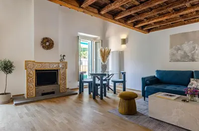 a living room with a blue couch and a table at Domus Beato Angelico in Rome