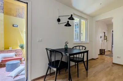a dining room with a black table and chairs at Domus Beato Angelico in Rome