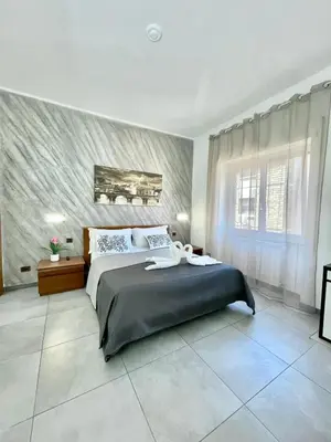 a bedroom with a large bed and a large window at gt TRASTEVERE STATION HOUSE in Rome