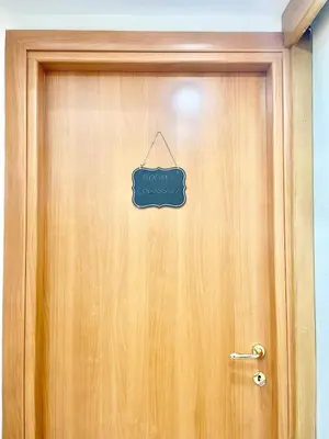 a wooden door with a sign on it at gt TRASTEVERE STATION HOUSE in Rome