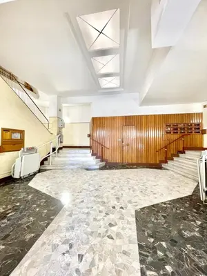 a large hall with a staircase and a lobby at gt TRASTEVERE STATION HOUSE in Rome