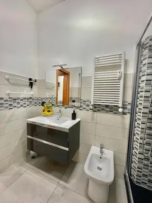a bathroom with a sink and a toilet and a mirror at gt TRASTEVERE STATION HOUSE in Rome