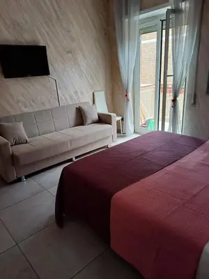 a living room with a bed and a couch at gt TRASTEVERE STATION HOUSE in Rome