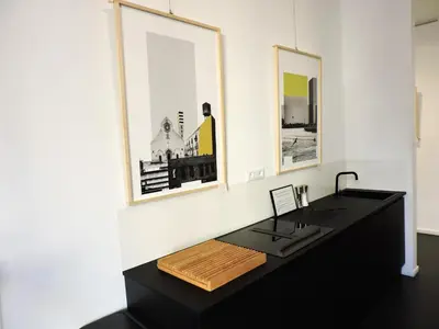 a black desk in a room with two pictures on the wall at Art Lab Residence in Rome