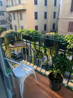a balcony with a chair and a table and plants at Art Lab Residence in Rome