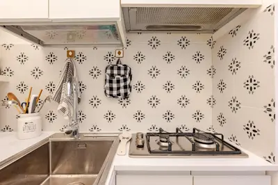 a kitchen with a sink and a stove top oven at Modern apartment in Portuense in Rome