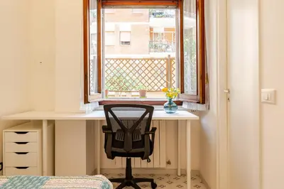 a desk with a chair in front of a window at Modern apartment in Portuense in Rome