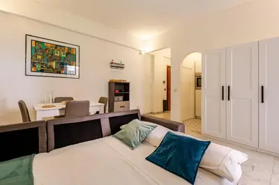 a bedroom with a bed and a living room at Modern apartment in Portuense in Rome