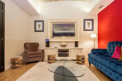 a living room with a blue couch and a tv at La Casa dei Sogni Roma in Rome