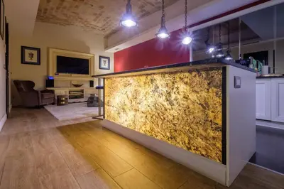 a large stone wall in the middle of a living room at La Casa dei Sogni Roma in Rome