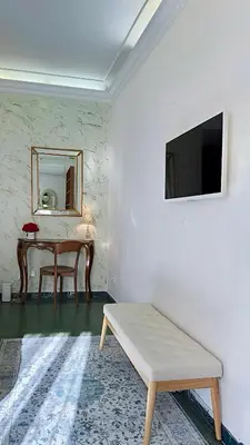 a room with a table and a mirror and a bench at Sonia Monteverde Apartment per 4 in Rome