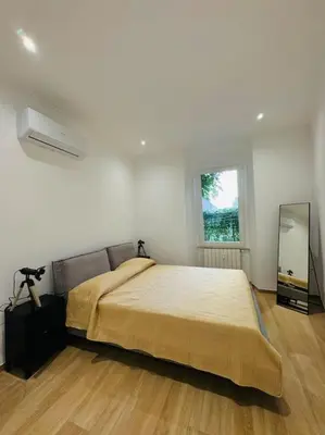 a bedroom with a large bed and a mirror at Al No60 in Rome