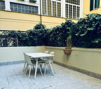 a white table and chairs in front of a building at Al No60 in Rome