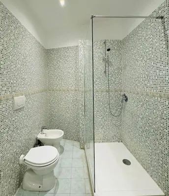 a bathroom with a toilet and a shower and a sink at Al No60 in Rome