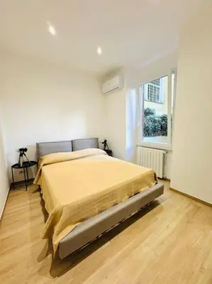 a bedroom with a bed in a white room at Al No60 in Rome